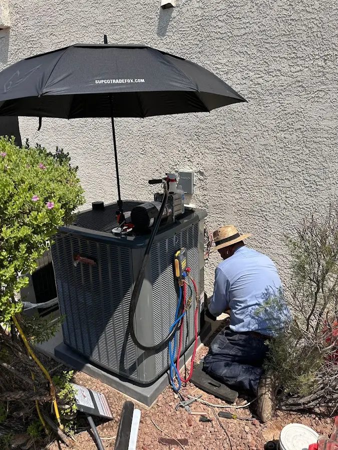 HVAC technician performing outdoor AC maintenance in Warsaw